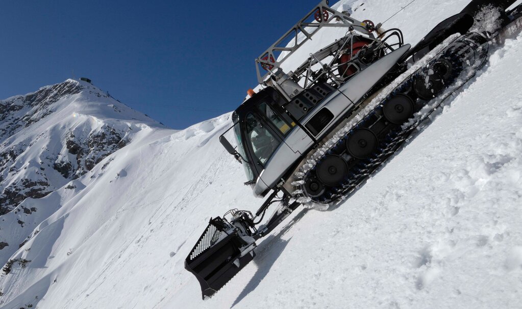 Slope grooming on one of the steepest groomed ski runs in the world