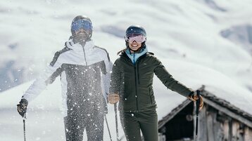 smiling skiers with fresh snow