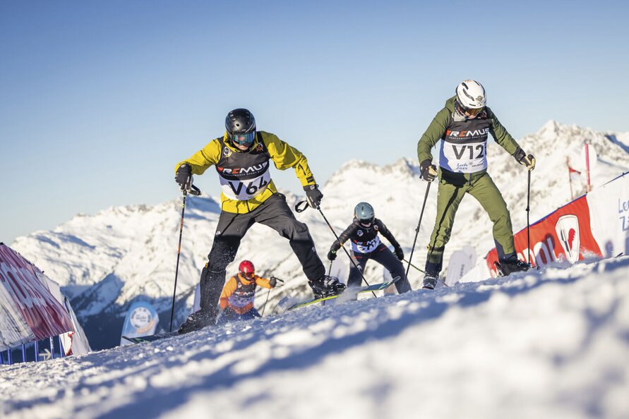 Skiers racing in the Alps at Der Weiße Ring