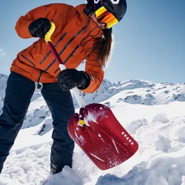 Person using a shovel at the avalanche training area.