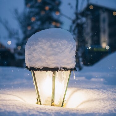 Snow-capped lantern and a festive wintry background.