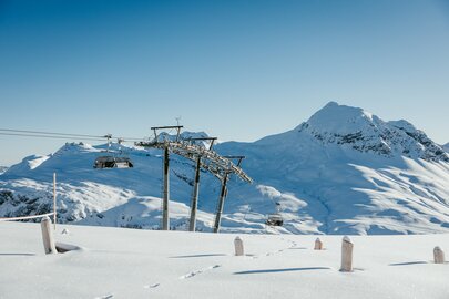 Snow-covered mountains and ski lift at Lech Zürs ski resort.