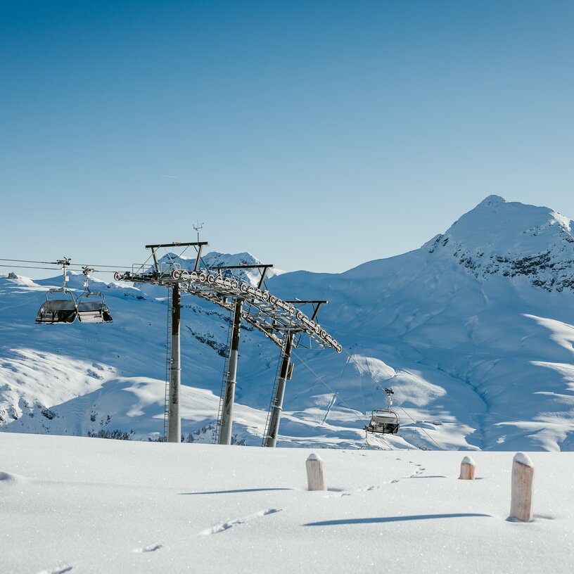 Snow-covered mountains and ski lift at Lech Zürs ski resort.
