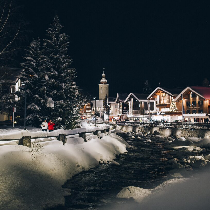 Snowy town and river at Lech Zürs ski resort at night.