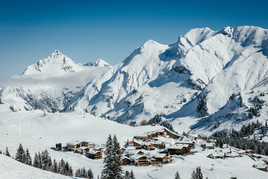 Snow-covered mountains and a charming alpine village at Lech Zürs ski resort.