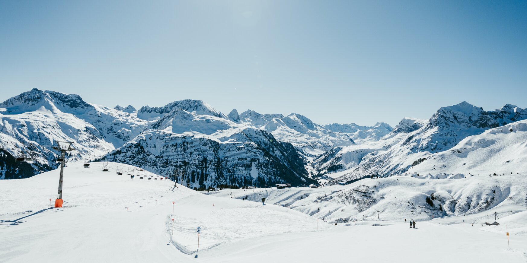 Snow-covered mountains and blue sky at Lech Zürs ski resort.
