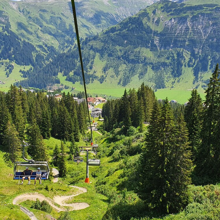 View of a cable car and green mountain landscape at Kriegerhorn family mountain.