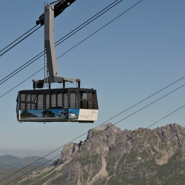 Cable car at Rüfikopf panoramic mountain with alpine view.