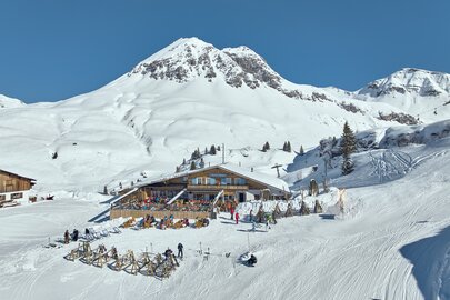 Restaurant Trittalpe under sunny winter skies at the ski area.