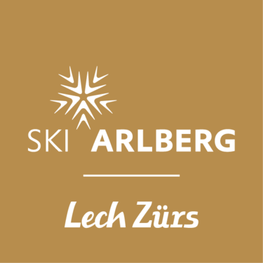 Logo von Ski Arlberg Lech Zürs auf goldenem Hintergrund.