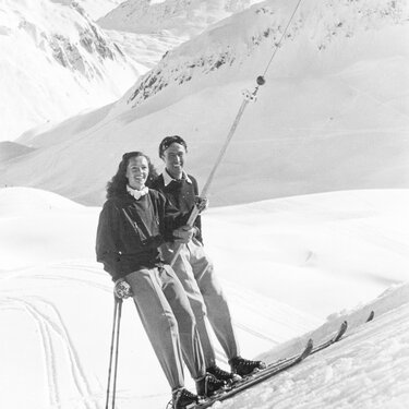 Smiling couple on a ski lift at Ski Arlberg ski resort.