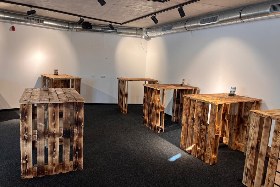 A set of rustic wooden tables at Bistro Rauz.