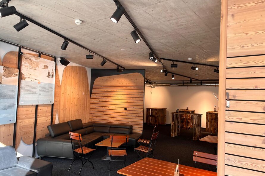 Seating area at Bistro Rauz with wooden walls and modern decor.