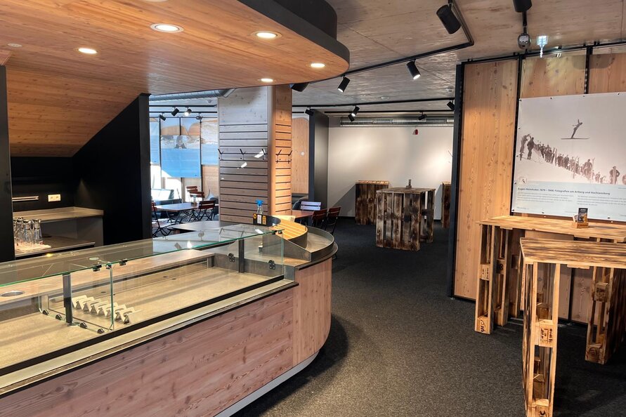 Interior of Bistro Rauz with wooden decor and bar.