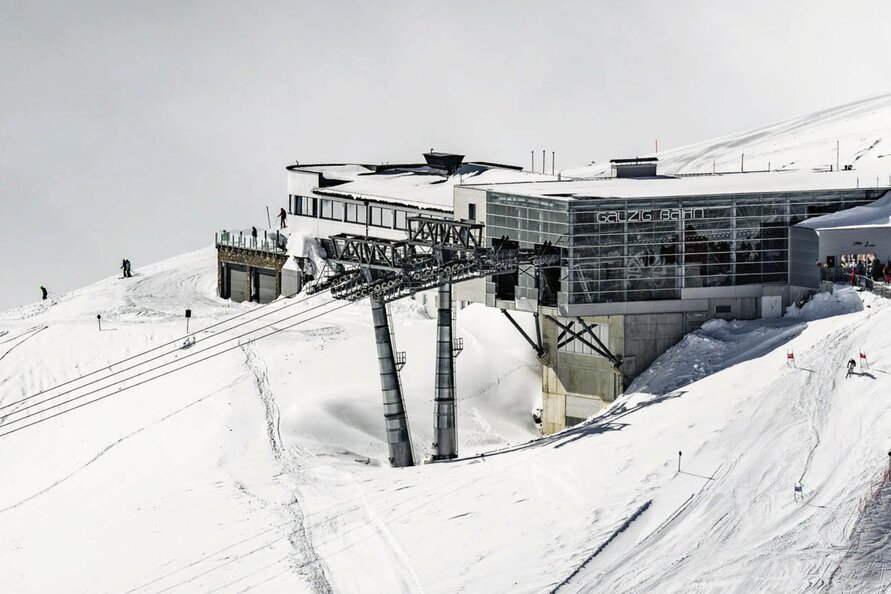 Skiers near the snowy Galzig Restaurant in winter.
