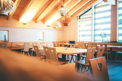 A cozy interior of the Gampen Restaurant with wooden furniture.