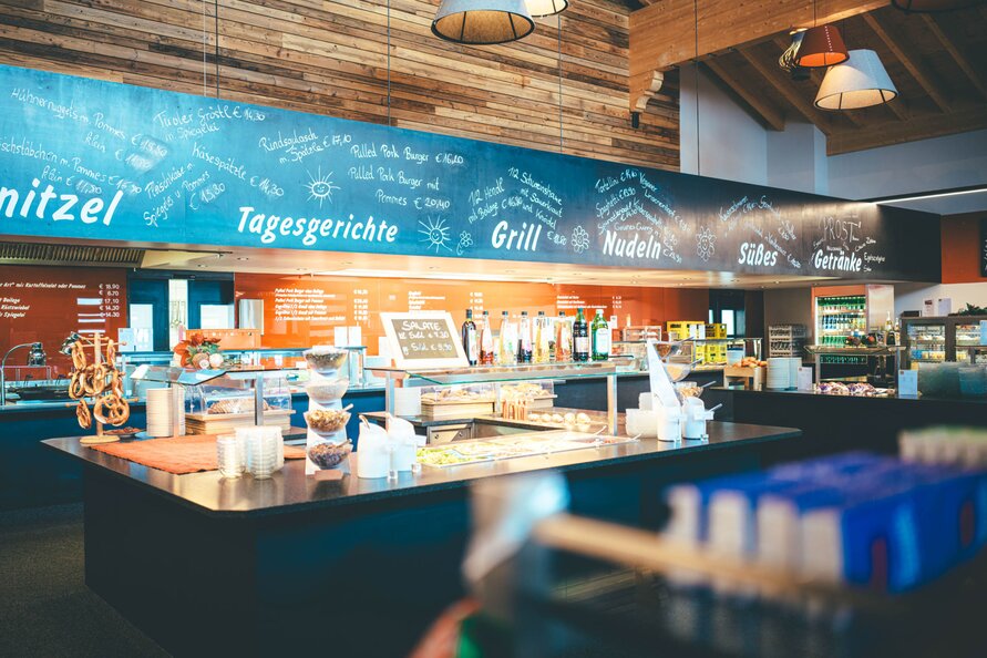 Interior of Gampen Restaurant with menu items on the board.