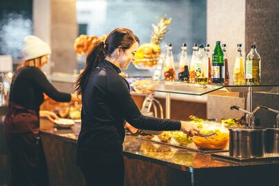 Women serving themselves at the buffet at Rendl Restaurant.