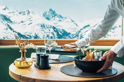 A set table at Verwallstube with mountain view in the background.