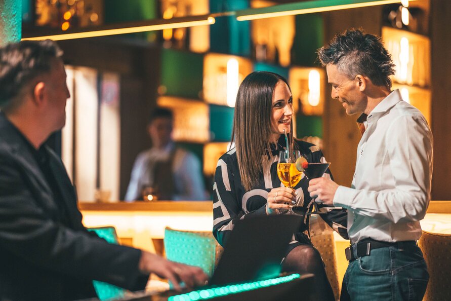  Man and woman conversing with drinks at Restaurant Verwallstube. 