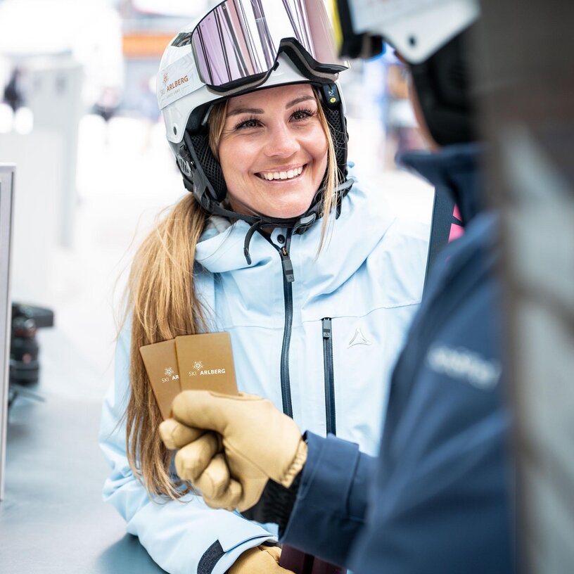 Woman with ski pass at a checkpoint.