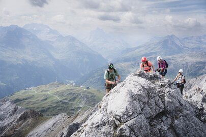 Group of climbers on a rocky ridge in the Alps.
