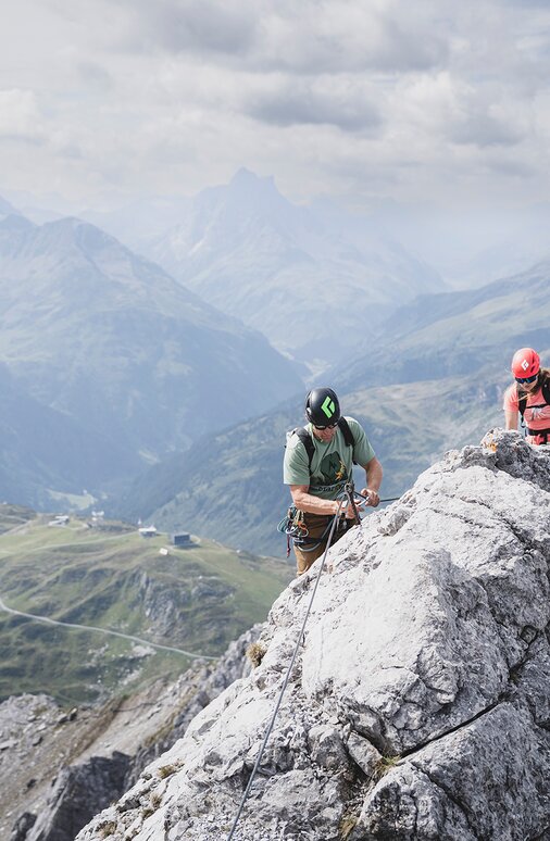Group of climbers on a rocky ridge in the Alps.