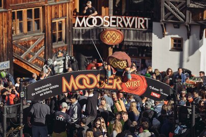 Crowd at MooserWirt, St. Anton, with wooden decor element above the entrance.