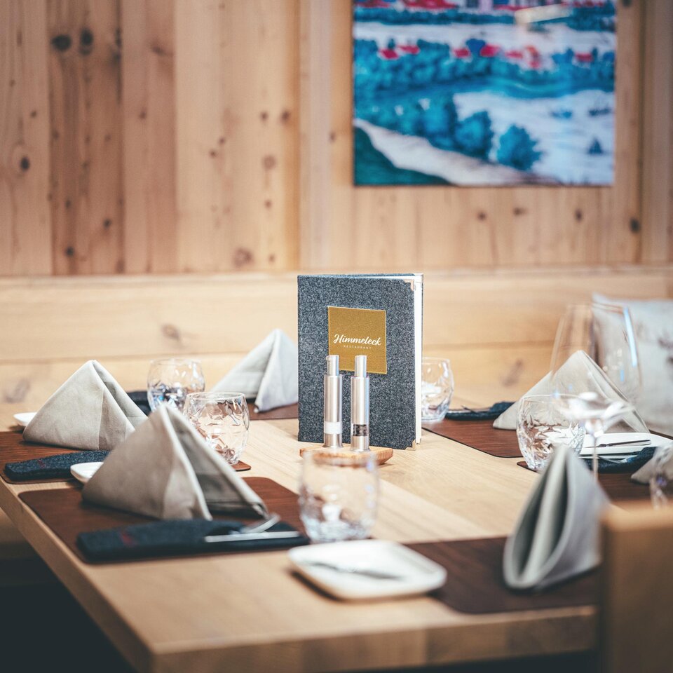 An elegantly set table for an evening dinner in a restaurant.
