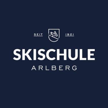 Logo of Arlberg ski school, established 1921, on a dark blue background.