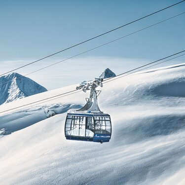 Seilbahn über verschneiten Bergen mit der Aufschrift "Valluga".